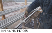 A Worker Skillfully Handling Metal Bars at a Construction Site in a Dedicated Manner. Стоковое видео, видеограф Громов Александр / Фотобанк Лори