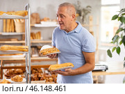 Elderly man with bocadillo sandwich in bakery. Стоковое фото, фотограф Яков Филимонов / Фотобанк Лори