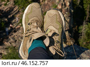 Lightweight hiking boots in green-brown on the feet. Стоковое фото, фотограф Екатерина Якименко / Фотобанк Лори