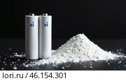 Two potassium ion batteries and a pile of white powder of cathode material on a black background.  AI generative. Стоковое AI-изображение, AI-художник Роман Дзюбало / Фотобанк Лори
