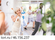 Elderly woman practicing lindy hop moves with african american partner. Стоковое фото, фотограф Яков Филимонов / Фотобанк Лори