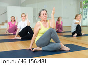 Active senior women practicing twisting yoga poses. Стоковое фото, фотограф Яков Филимонов / Фотобанк Лори