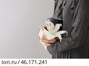 Woman with mortuary urn and lily flower on light background. Стоковое фото, фотограф Pixel_shot / Фотобанк Лори