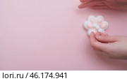 Taba paw pink and white colorful anti-stress toys squirt on baby's hand. Стоковое видео, видеограф Терехова Марина / Фотобанк Лори