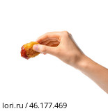 Female hand with tasty chicken nugget on white background. Стоковое фото, фотограф Pixel_shot / Фотобанк Лори