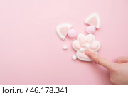 Taba paw pink and white colorful anti-stress toys squirt on baby's hand. Стоковое фото, фотограф Терехова Марина / Фотобанк Лори