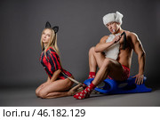 Couple engaged in playful roleplay with themed outfits and accessories. Стоковое фото, фотограф Гурьянов Андрей / Фотобанк Лори