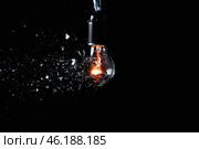 Breaking of light bulb on dark background. Стоковое фото, фотограф Pixel_shot / Фотобанк Лори