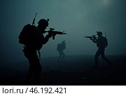 Silhouettes of military soldiers maneuver through thick fog, preparing for an active confrontation. Atmosphere is tense as the sun begins to rise. The military goes on the night attack. Generative AI. Стоковое AI-изображение, AI-художник Юлия Петровская / Фотобанк Лори