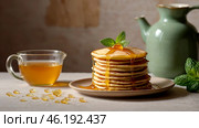 Delicious pancakes with honey and mint leaves on a stylish plate in a beige kitchen. The concept of the Russian holiday Maslenitsa. Стоковое AI-изображение, AI-художник Photojuli / Фотобанк Лори