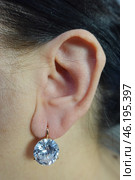 Ухо с серьгой в виде брильянта, алмаза. Ушная раковина, лор. The ear with a stud in the shape of a diamond. Auricle, ENT. Стоковое фото, фотограф Юрий Пуликов / Фотобанк Лори