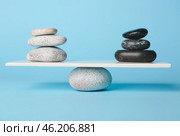 Spa stones on teeterboard against color background. Concept of balance. Стоковое фото, фотограф Pixel_shot / Фотобанк Лори