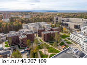 Aerial view of Novosibirsk State University among the Siberian forests in autumn, the Ob river on the horizon, and the construction of its new buildings. Стоковое фото, фотограф Сергей Фролов / Фотобанк Лори