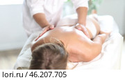 Hands of old masseur conducting back massage for woman client in procedure room. Стоковое видео, видеограф Яков Филимонов / Фотобанк Лори