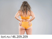 Overweight thigh, woman with fat hips, back and buttocks, obesity female body with cellulite on gray background. Стоковое фото, фотограф Станислав Тарко / Фотобанк Лори