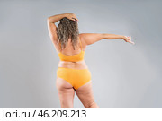Overweight thigh, woman with fat hips, back and buttocks, obesity female body with cellulite on gray background. Стоковое фото, фотограф Станислав Тарко / Фотобанк Лори