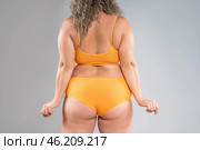 Overweight thigh, woman with fat hips, back and buttocks, obesity female body with cellulite on gray background. Стоковое фото, фотограф Станислав Тарко / Фотобанк Лори
