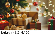 Big Wrapped Gift Boxes Is Under the Christmas Tree. Beige and Gold Gift-Wrapped Box with Ribbon for Friends, Relatives. Close up. Packaging of Xmas Presents. Festive Decorations. Preparing for Holiday. Стоковое AI-видео, аниматор Марина Демидюк / Фотобанк Лори