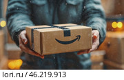 Courier holding a cardboard box with a famous logo during snowfall. Стоковое AI-видео, аниматор Юрий Поздников / Фотобанк Лори