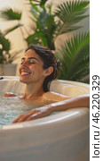 Woman relaxing in hot tub with tropical plants. Стоковое AI-видео, аниматор Юрий Поздников / Фотобанк Лори