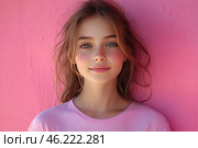 A young girl with natural beauty standing against a bright pink wall. She is wearing a simple pink T-shirt that matches the background color. Her skin is fair, with a slight blush and freckles, and her lips are slightly pink. The girl has expressive blue eyes, slightly tousled chestnut-colored hair, and a relaxed, friendly expression. The photo conveys an atmosphere of youth, freshness, and lightness. Стоковое AI-изображение, AI-художник Анна Кривицкая / Фотобанк Лори