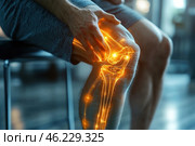 A person sitting on a chair and holding his knee, experiencing pain. The visual effect shows the internal structure of the joint - bones, ligaments and articular surfaces, illuminated with a bright orange light, symbolizing inflammation or damage. The surrounding environment is blurred, creating an emphasis on the knee and its problems. This image can be interpreted as an illustration of joint pain, arthritis, injury or degenerative diseases. Стоковое AI-изображение, AI-художник Анна Кривицкая / Фотобанк Лори