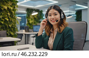 A pretty girl is a call center employee. A girl with headphones is sitting in the office and working with customer requests. Стоковое AI-изображение, AI-художник Антон Слабоспицкий / Фотобанк Лори