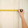 Hands of a woman measuring a kitchen cabinet with a yellow tape measure. Home improvement and renovation concept. Стоковое фото, фотограф Андрей Журавлев / Фотобанк Лори