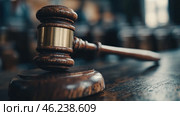 Wooden judge's gavel on courtroom desk symbolizing justice and authority in legal proceedings. Стоковое AI-изображение, AI-художник Olga Didraga / Фотобанк Лори