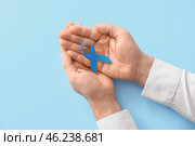 Male hands with blue ribbon on color background. Prostate cancer awareness concept. Стоковое фото, фотограф Pixel_shot / Фотобанк Лори