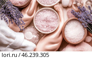 Luxurious lavender spa essentials with towels, salts, and oils for relaxation. Стоковое AI-изображение, AI-художник Olga Didraga / Фотобанк Лори