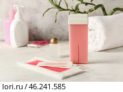 Liposoluble wax cartridge and strips on table. Стоковое фото, фотограф Pixel_shot / Фотобанк Лори