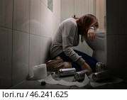 Young vomiting woman near toilet bowl. Concept of alcoholism. Стоковое фото, фотограф Pixel_shot / Фотобанк Лори