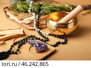 Composition with Tibetan singing bowl, gemstones, beads and Palo Santo on color background. Стоковое фото, фотограф Pixel_shot / Фотобанк Лори