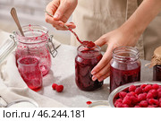 Woman with jars of sweet raspberry jam. Стоковое фото, фотограф Pixel_shot / Фотобанк Лори
