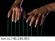 Hands of puppeteer on dark background. Стоковое фото, фотограф Pixel_shot / Фотобанк Лори
