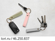 Keys with leather keychains on light background. Стоковое фото, фотограф Pixel_shot / Фотобанк Лори