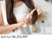 Beautiful young woman with hair spray at home, closeup. Стоковое фото, фотограф Pixel_shot / Фотобанк Лори