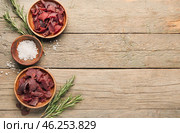 Spicy beef jerky on wooden background. Стоковое фото, фотограф Pixel_shot / Фотобанк Лори