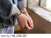 Female hostage with handcuffs outdoors. Стоковое фото, фотограф Pixel_shot / Фотобанк Лори