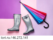 Stylish umbrella and gumboots on color background. Стоковое фото, фотограф Pixel_shot / Фотобанк Лори