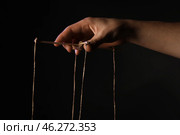 Hand of puppeteer on dark background. Стоковое фото, фотограф Pixel_shot / Фотобанк Лори
