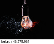 Breaking of light bulb on dark background. Стоковое фото, фотограф Pixel_shot / Фотобанк Лори