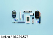 Glucometers with lancet pens, test strips and syringes on color background. Diabetes concept. Стоковое фото, фотограф Pixel_shot / Фотобанк Лори