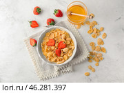 Bowl with healthy cornflakes, honey and strawberry on white table. Стоковое фото, фотограф Pixel_shot / Фотобанк Лори