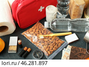 Necessities for emergency bag on dark table, closeup. Стоковое фото, фотограф Pixel_shot / Фотобанк Лори