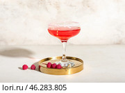 Glass of tasty cosmopolitan cocktail on light background. Стоковое фото, фотограф Pixel_shot / Фотобанк Лори