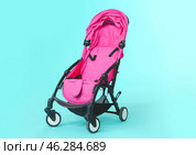 Modern baby stroller on color background. Стоковое фото, фотограф Pixel_shot / Фотобанк Лори