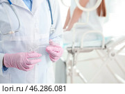 Female gynecologist with vaginal speculum in clinic, closeup. Стоковое фото, фотограф Pixel_shot / Фотобанк Лори
