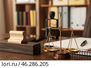 Scales of justice with stamp on table of notary public. Стоковое фото, фотограф Pixel_shot / Фотобанк Лори